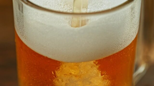 Super slow motion of pouring beer into pint at high speed. Filmed on high speed cinema camera, 1000 fps. Camera placed on high speed cine bot. Macro shot.