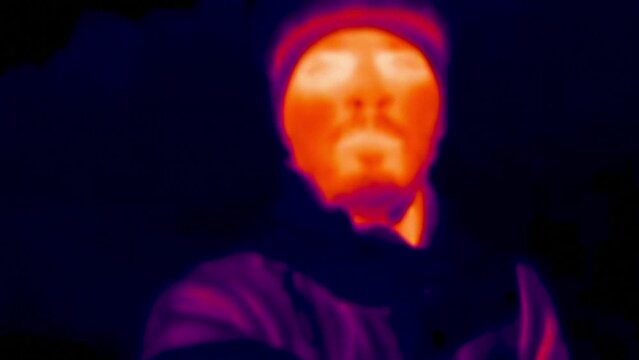 Close up portrait of cyclist in the forest, thermal vision view