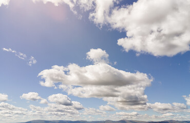 blue sky with clouds over mountain range