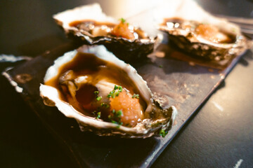oysters on their shell with seasoning ready to eat
