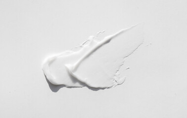 Fototapeta na wymiar smears of white cream on a white background. Beauty cream texture.