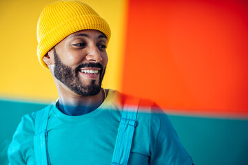 Image of an handsome young man posing on colored backgrounds wearing colorful trendy clothes....