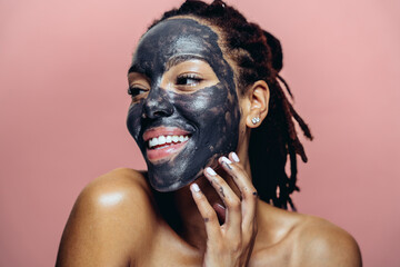 Beautiful woman making skin and facial beauty treatments. Studio shot with focus on cosmetic and skin care concepts