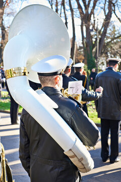 Trumpeter with helicon of naval band orchestra in park