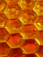 Beekeeping - close-up of the cells of a frame partially filled with honey