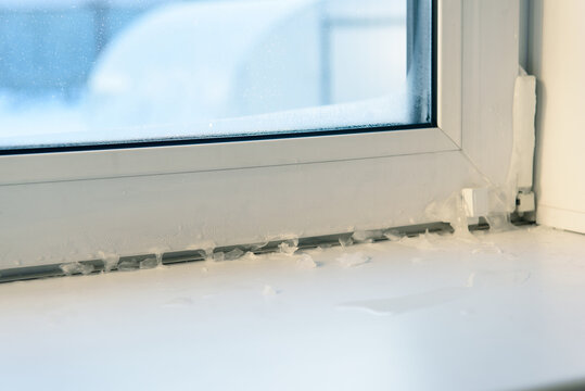 icicles on the window indoors. incorrect window installation, window adjustment, heating problems.