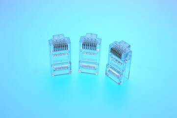 Connector rg 45 for internet cable. Several connectors lie on a multi-colored background. Close-up