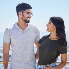 Fototapeta premium Love, hug and Indian couple with smile, bonding and loving together outdoor. Romance, man and woman on seaside holiday, break and weekend for happiness, relationship and vacation and hug in marriage