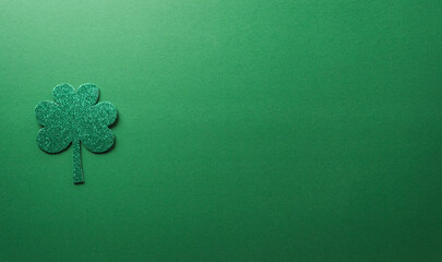 Happy St Patrick's Day decoration concept made from shamrocks ( clover leaf) on green background.