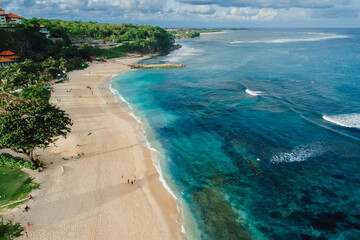 Fototapeta na wymiar Beach with blue ocean and waves in Bali island. Aerial view