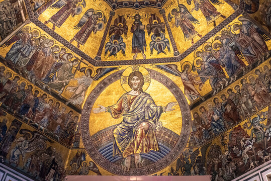 Golden mosaic composing religious mural inside catholic church in Florence showing Jesus surrounded by scenes of heaven and hell