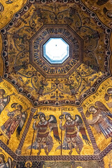 Close-up on golden religious mosaic decorating the dome interior of catholic church in Florence