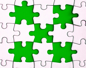Missing jigsaw puzzle on green background with customizable space for text or ideas. Copy space