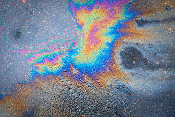 Abstract background from motor oil, gas or petrol spilled on asphalt
