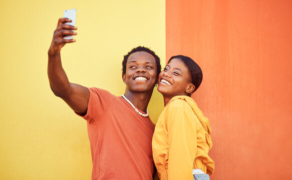 Gen z, young black couple happy in selfie with smartphone and influencer with post for social media against color wall background. Smile in picture, fashion mockup and tech with man and woman youth