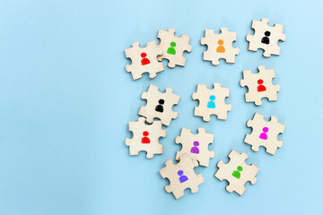 Business image of wooden puzzle with people icons over blue background, human resources and management concept