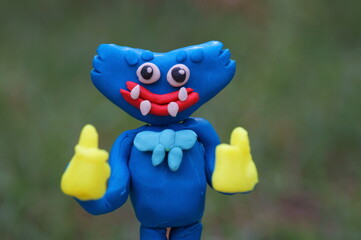 A bright blue monster made of plasticine. A character for children. Ideas for Halloween.