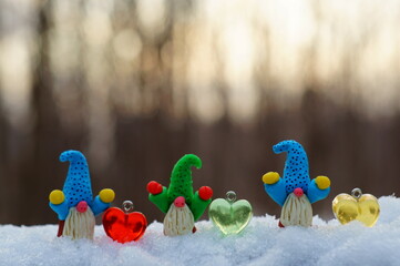 Figurines of little gnomes and colorful toy hearts.