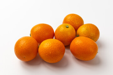 Kumquats on a white background