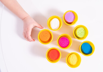 Colourful plasticine for modeling on a white background