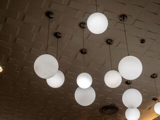 Round lamp hanging alternating high and low decorating the ceiling
