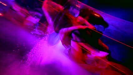 tender embrace of two lesbians women inside depth of amazing fabulous pool or bath, female figures