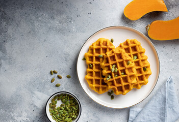 Pumpkin spice waffles on gray table. homemade healthy breakfast. top view, copy space.