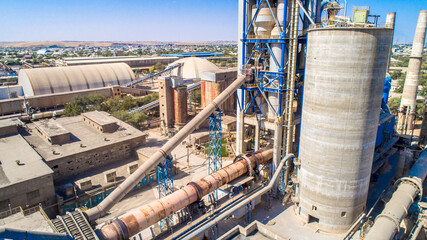 Industrial plant top view. Cement plant, raw material processing equipment. Manufactory with technological equipment. Sand destined to the manufacture of cement in a quarry.
