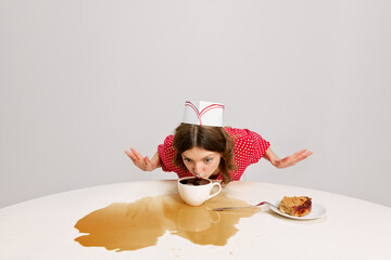 One young woman, strange waitress in 70s, 80s retro fashion style uniform sitting at table with coffee over grey background. Funny meme emotions, ad, sales