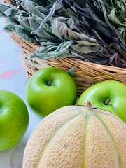 Still life with dried sage, green apples and melon