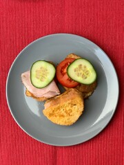 Fresh homemade sandwiches with ham, cucumber and tomato