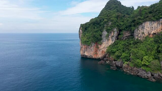 Top fly over and aerial view of Pileh lagoon in Phi Phi island of Thailand show beautiful area. Blue water in valley surround with mountain and some boat sail in ocean