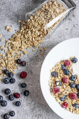 Oatmeal flaking with fresh blueberries, on a concrete background. healthy eating