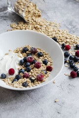 Oatmeal flaking with fresh blueberries, on a concrete background. healthy eating