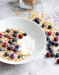 Oatmeal flaking with fresh blueberries, on a concrete background. healthy eating
