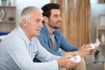 two mature men calmly playing a video game