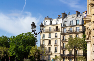 Old beautiful Parisian buildings near Buttes Chaumont park in the 19th arrondissement in Paris.