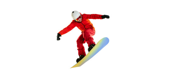 Portrait of active man, snowboarder in uniform riding on snowboard isolated over white studio...