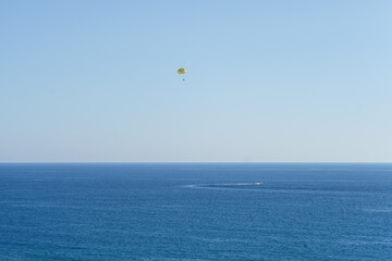 People Parasailing Over Sea Against Sky