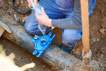 Construction worker, repairing a broken water pipe
Construction site with new Water Pipes in the ground. Plumber work repair water line connect.