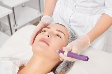 Beautician makes mesotherapy injection for rejuvenation woman face, anti aging non surgical...