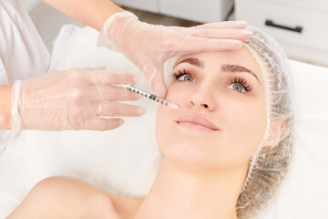 Cosmetologist makes fillers injection for lips augmentation and volume, non surgical cosmetic...