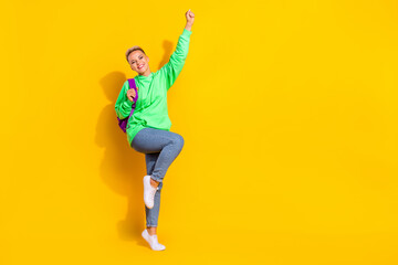 Fototapeta na wymiar Full size photo of delighted cheerful person raise fist celebrate triumph empty space isolated on yellow color background