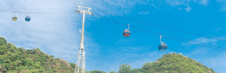 Panorama view gondola lift support tower with cable cars and Nui Lon mountain background in Vung...