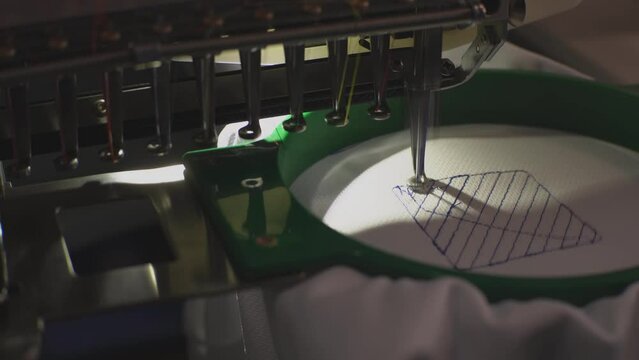 sewing machine embroiders blue inscription. High quality 4k footage