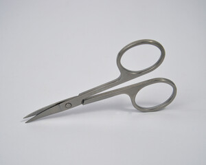 small scissors made of stainless material on a white background