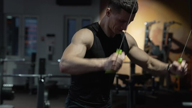 weight lifting. muscular athletic sportsman training in gym with weight lifting machine