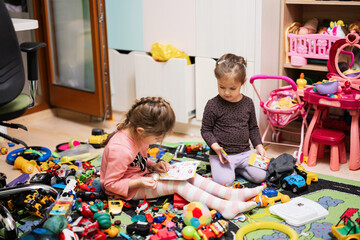 Сhildren have made a toy mess in the children's room and are playing with toys.