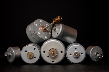 Various dc electric motors on black background