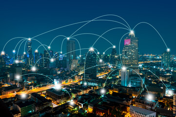 Smart city telecommunication network concept, connection lines over the night cityscape